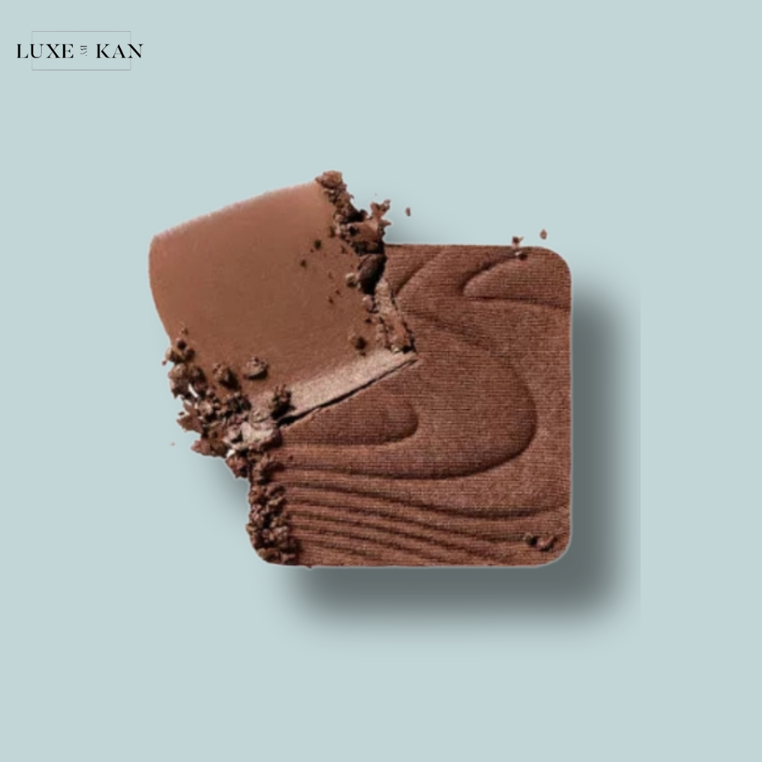 A creamy chocolate square with a textured surface, partially bitten, showcasing rich cocoa tones.