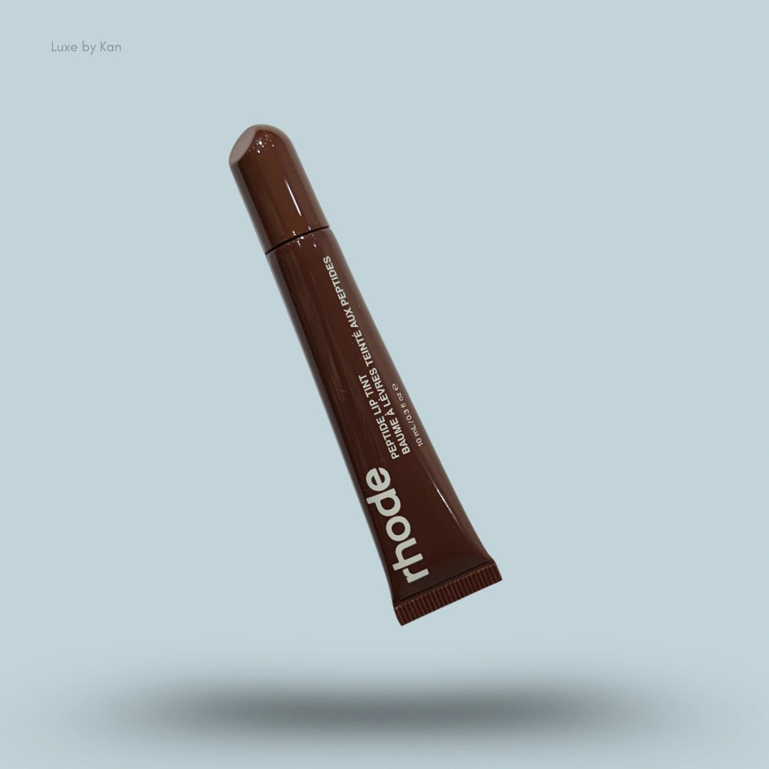 Rhode Peptide Lip Tint in a brown tube.