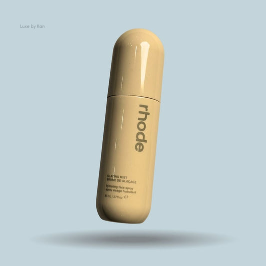 Rhode Glazing Mist in a cream, capsule-shaped bottle, featuring product details in black font.