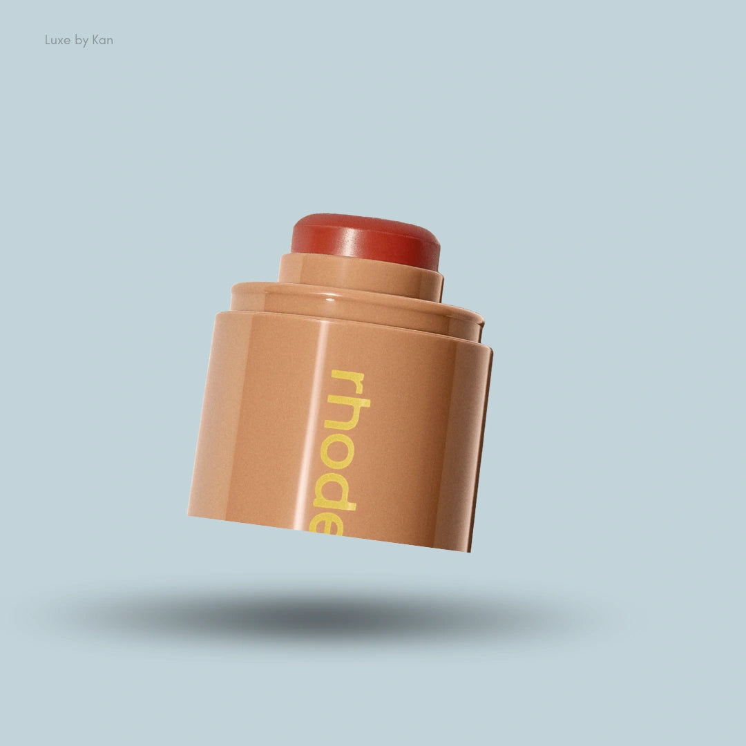 Rhode Pocket Blush in a warm terracotta shade, featuring a tan compact with yellow logo text over a blue background.
