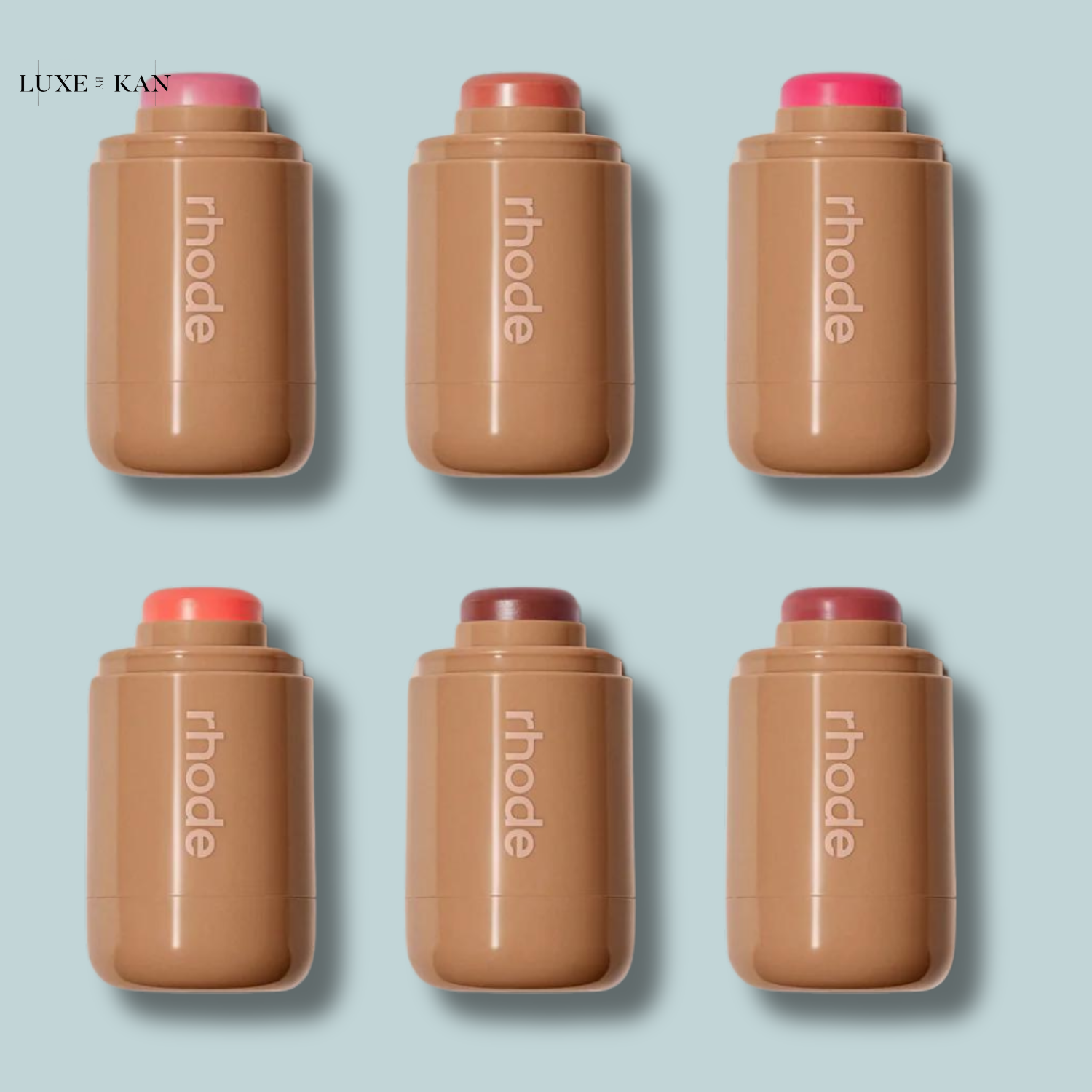 Six cylindrical rhode skin pocket blush cosmetics containers in various shades.