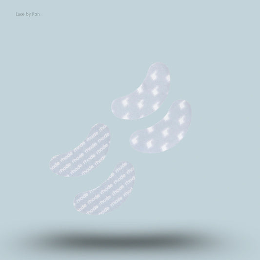 Rhode The Peptide Eye Prep Set featuring four translucent eye patches floating above a surface that projects a shadow.