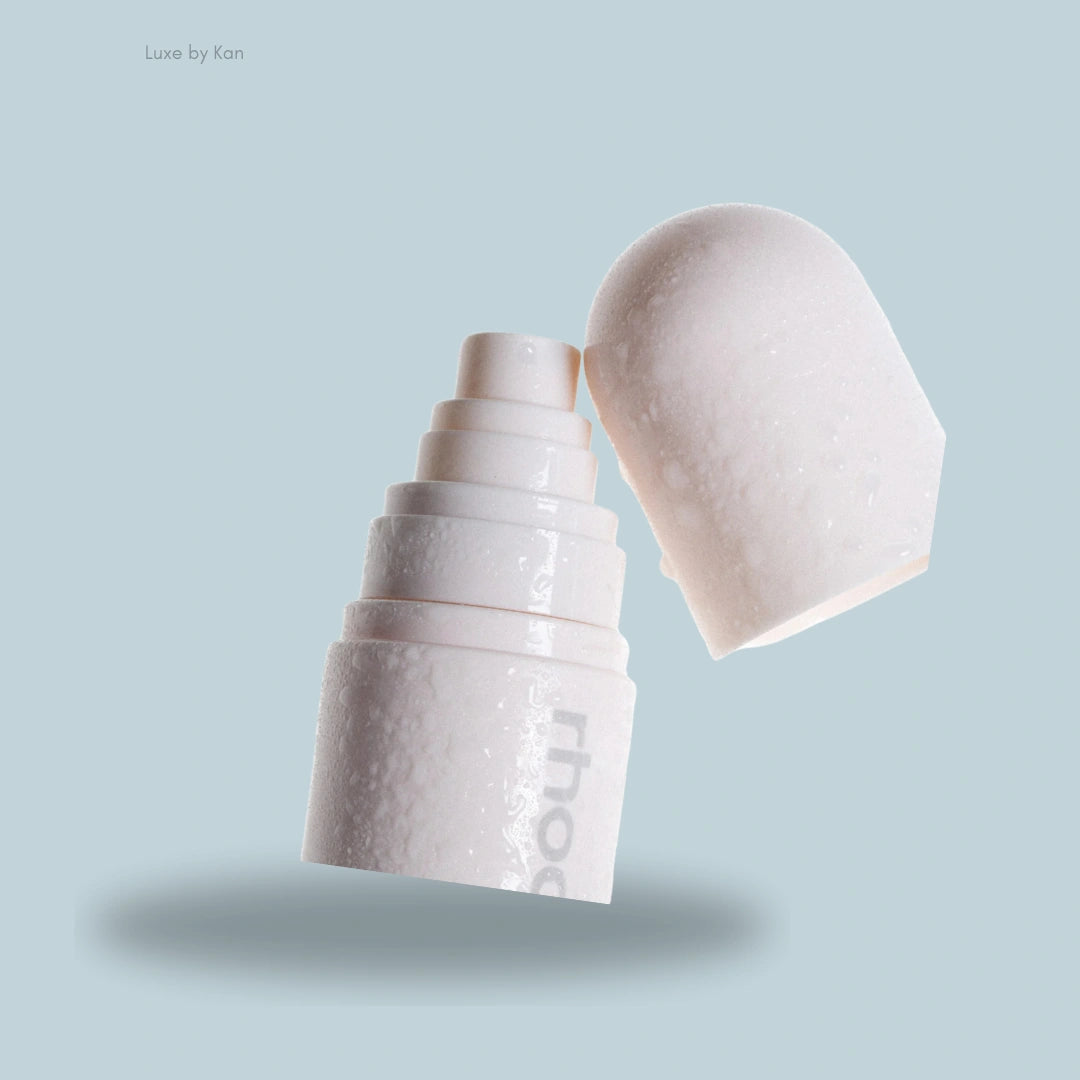 A close-up of the white Rhode Glazing Mist with a rounded cap, showcasing its sleek design and subtle sheen.