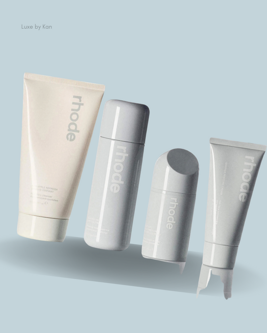 Four skincare products from the Rhode kit, featuring minimalist white and grey packaging.