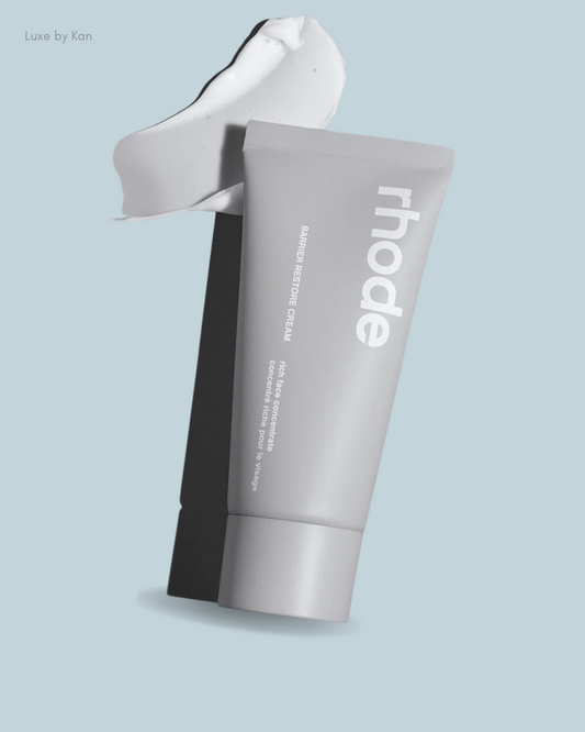 A gray tube of rhode Barrier Restore Cream with a dollop of cream above.