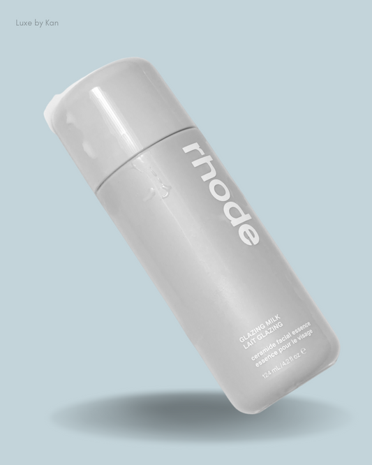 A sleek gray bottle of Rhode Glazing Milk, featuring bold white lettering.
