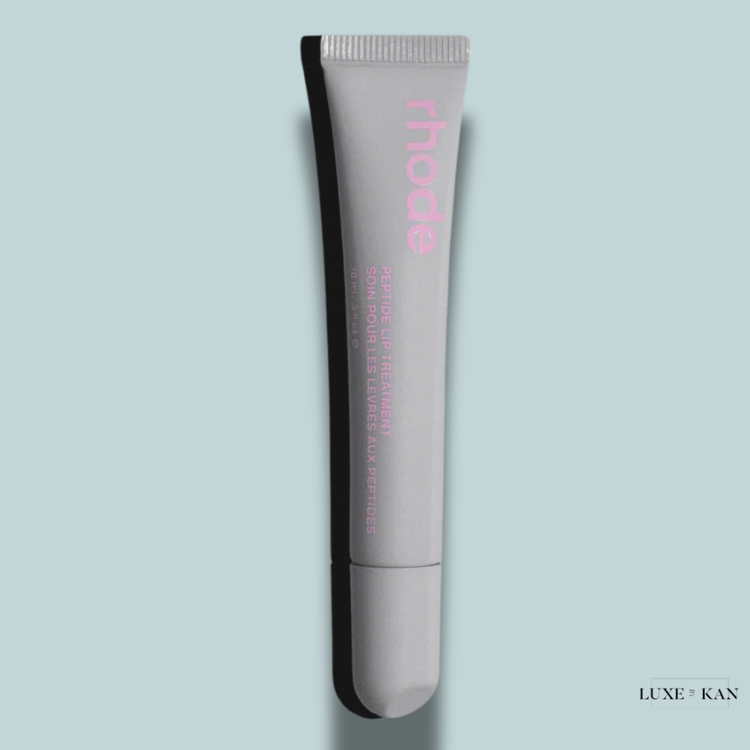 A sleek gray tube of Rhode Peptide Lip Treatment with pink lettering.