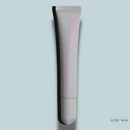 A sleek gray tube of Rhode Peptide Lip Treatment with pink lettering.
