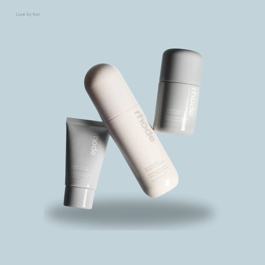 Three sleek skincare essentials from Rhode The Glow Set: Glazing Mist, Glazing Milk, and Barrier Butter, showcasing a modern, minimalist design.