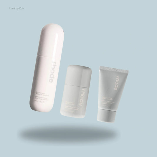 Three skincare products from Rhode, including a glazing mist, glazing milk, and barrier butter.