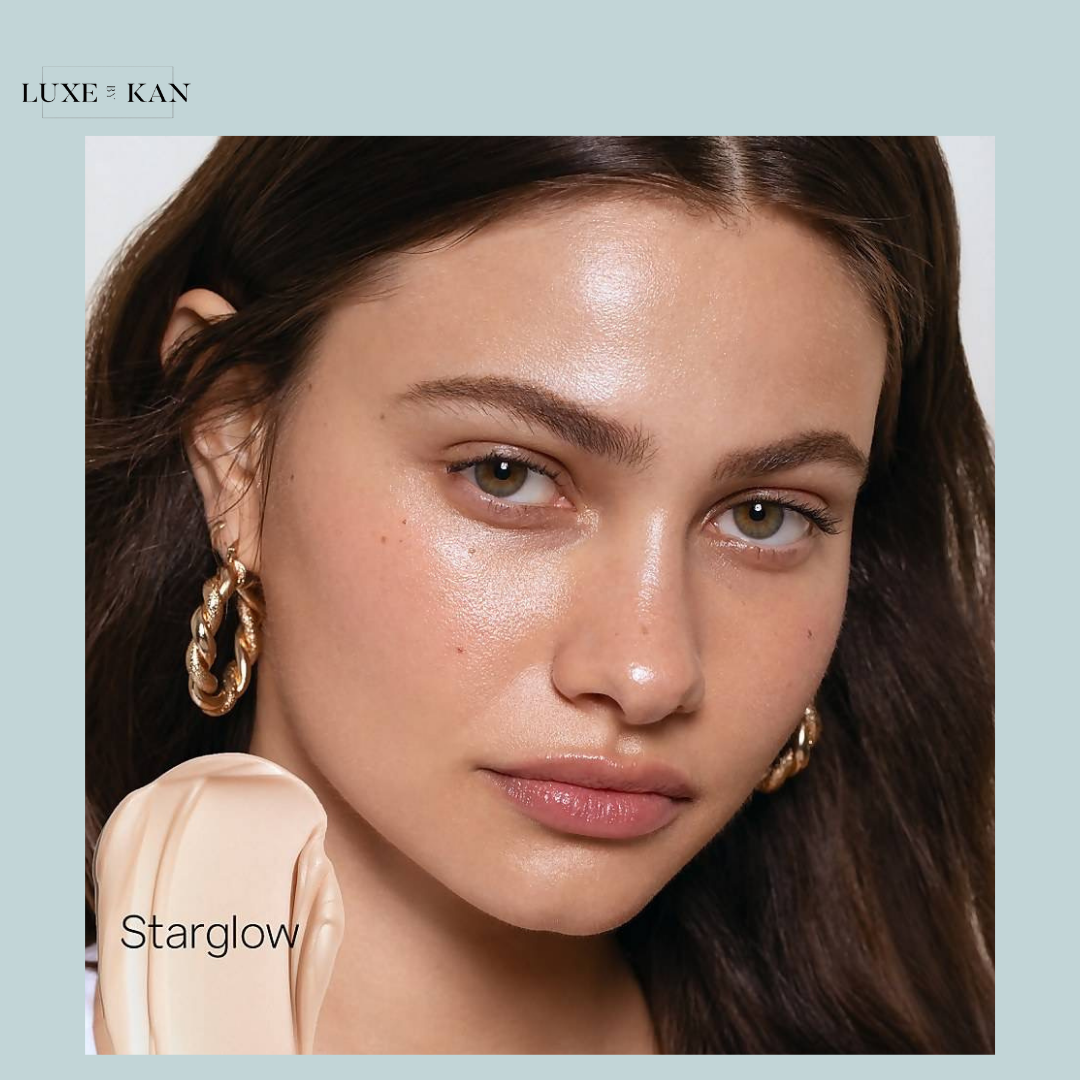 Model wearing Saie Glowy Super Gel in Starglow, showing radiant, dewy skin with a soft, natural glow and minimal makeup.