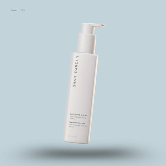 A square white bottle of Shani Darden Skincare Cleansing Serum with a pump.