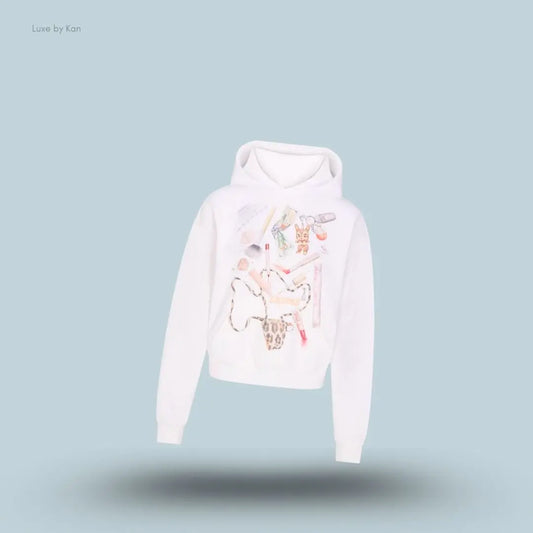SKIMS Cotton Fleece Classic Hoodie in Snow In My Bag, flat lay on light blue background