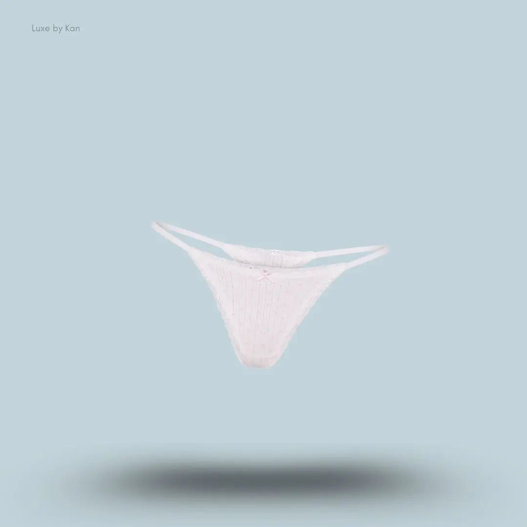 SKIMS Lightweight Cotton Pointelle Lace String Thong in Snow Peony Pin Dot, flat lay on light blue background