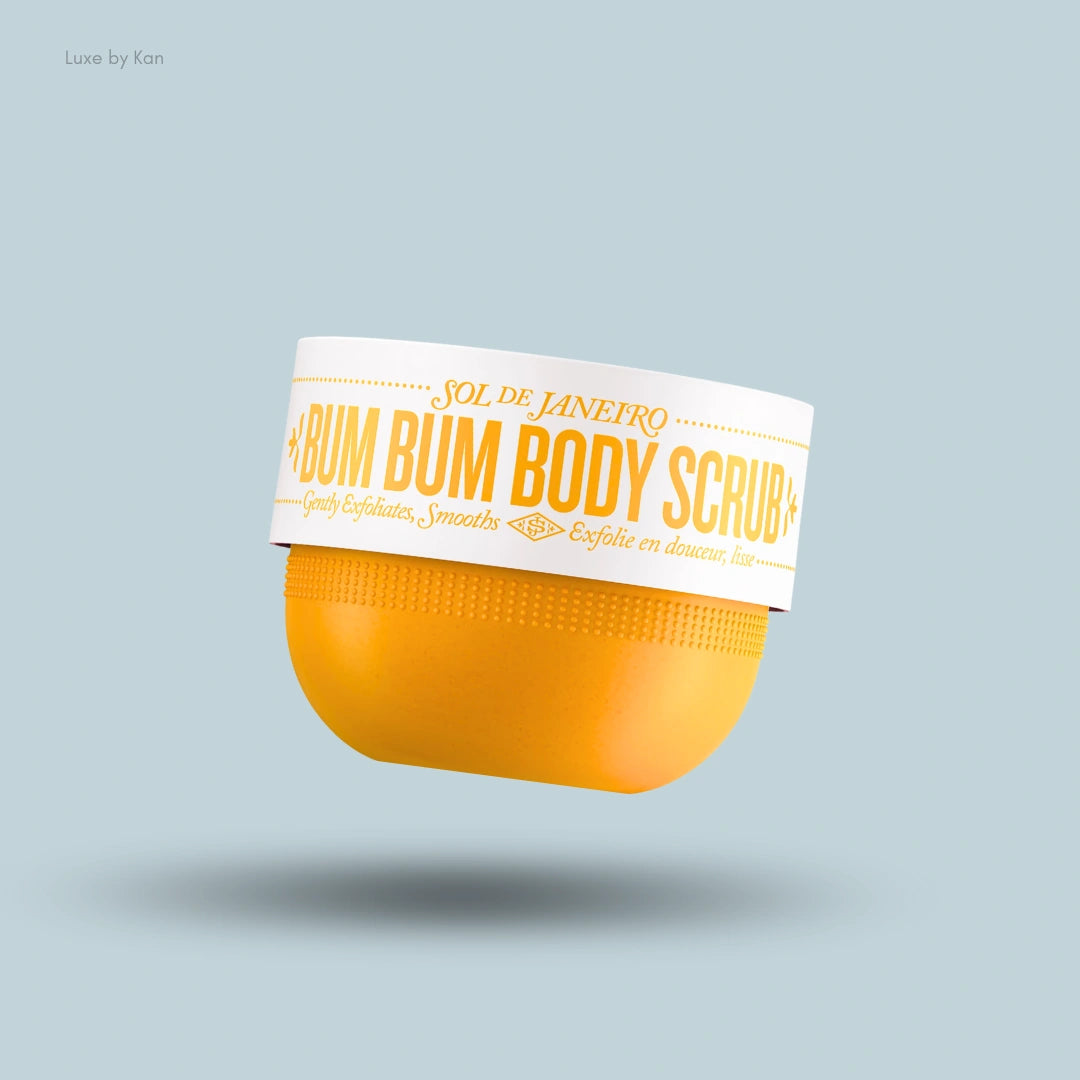 Sol de Janeiro Bum Bum Body Scrub in a bright yellow jar with a white lid, floating against a light blue background.