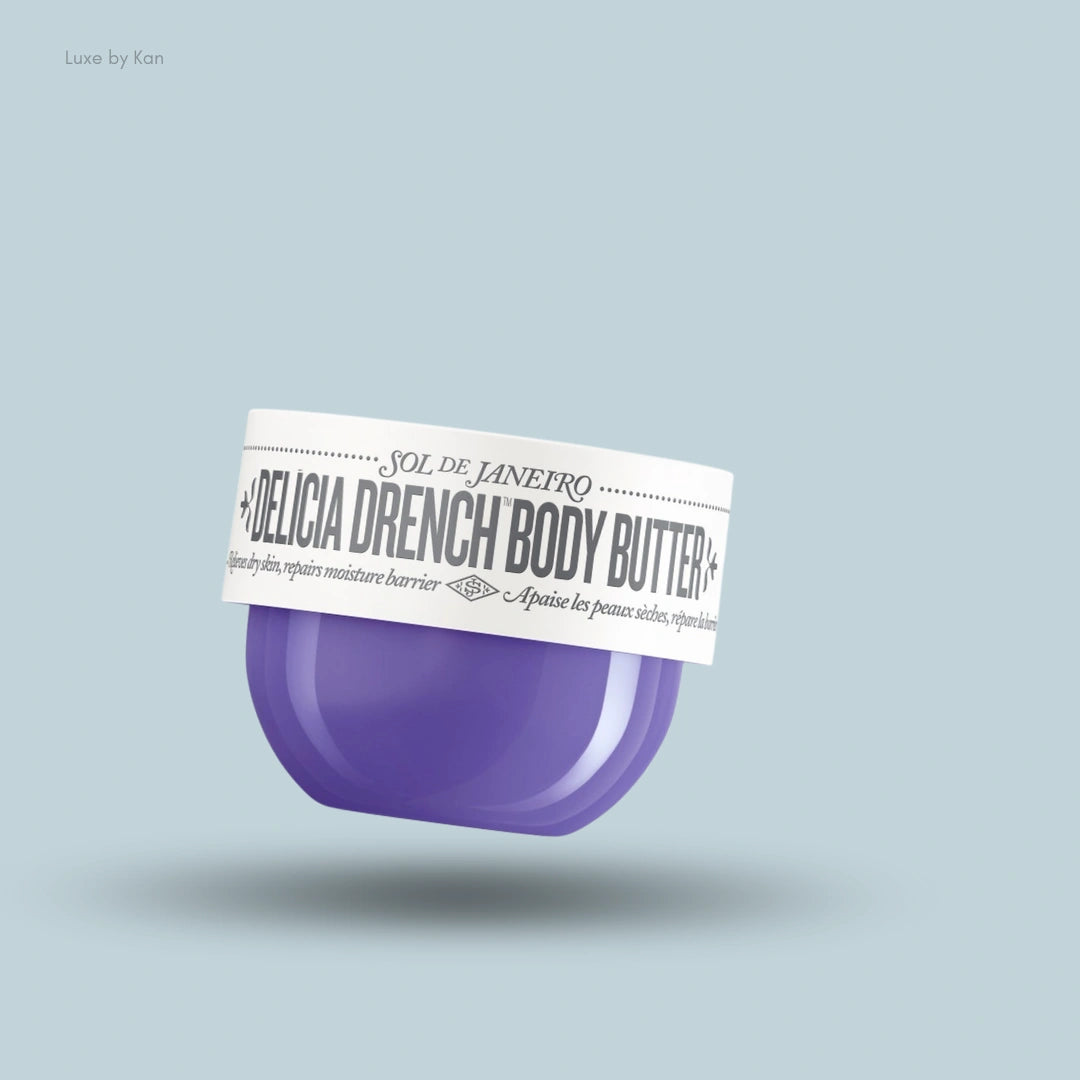 Sol de Janeiro Delicia Drench Body Butter in a purple jar with a white lid, floating against a light blue background.