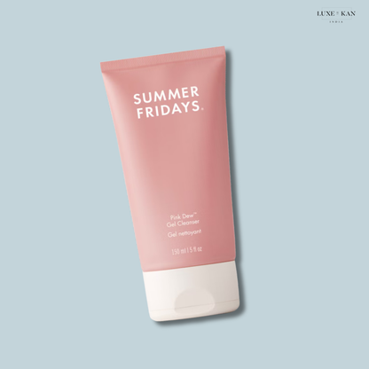A pink tube of Summer Fridays Pink Dew Gel Cleanser with a white cap is angled against a light blue background.