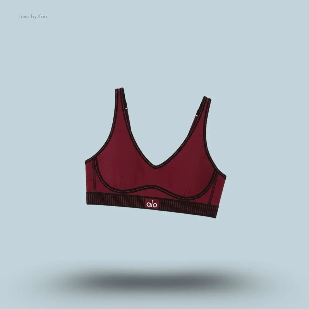 Alo Airlift Line Up Bra in Summer Romance Red, flat lay on light blue background