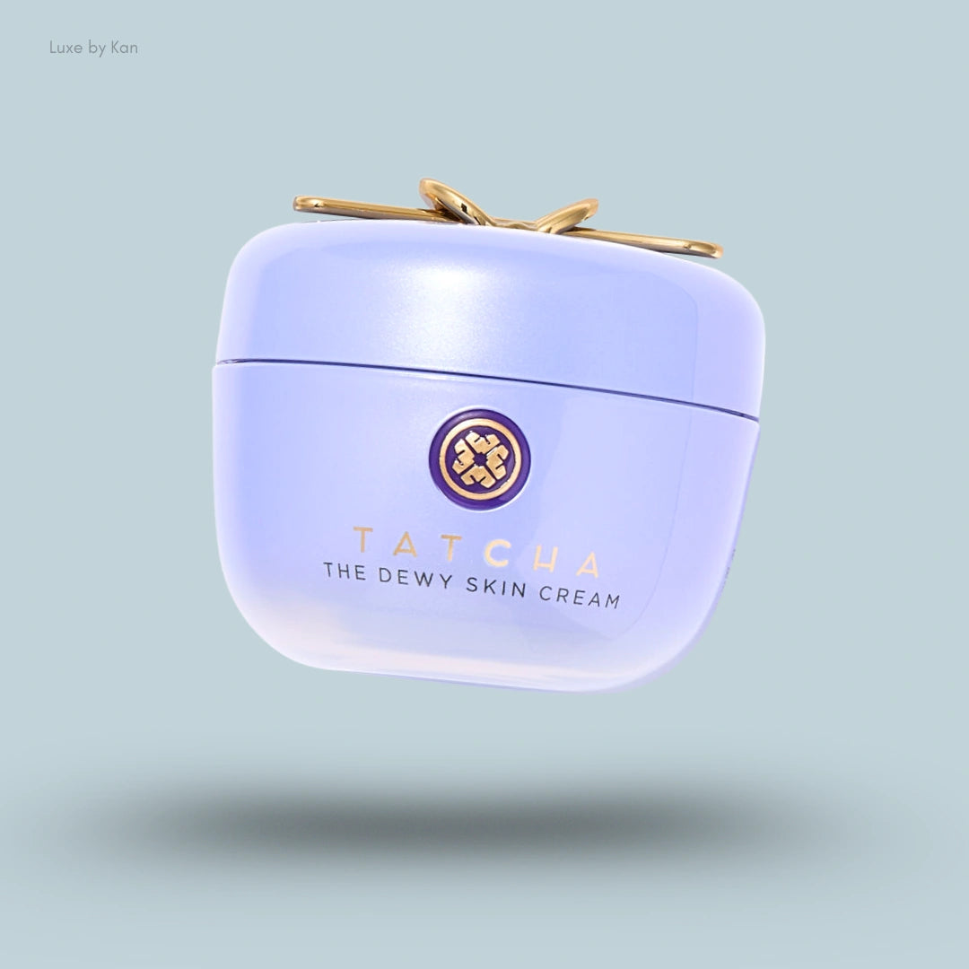 TATCHA The Dewy Skin Cream in a pale purple jar with gold bow and logo.