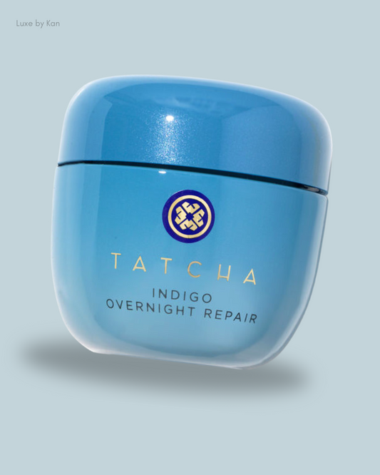 Tatcha Indigo Overnight Repair cream, packaged in a sleek blue jar, featuring gold text and a circular logo.