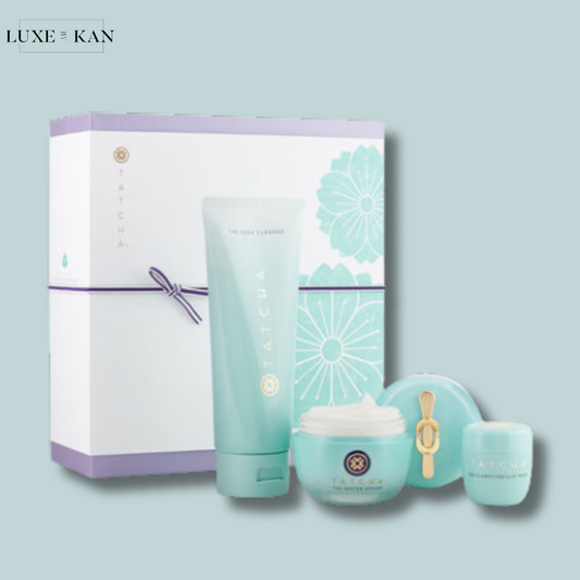 A Tatcha skincare gift of gratitude clarifying set featuring a cleanser, moisturizer, and serum, elegantly packaged in a mint green box with floral designs.