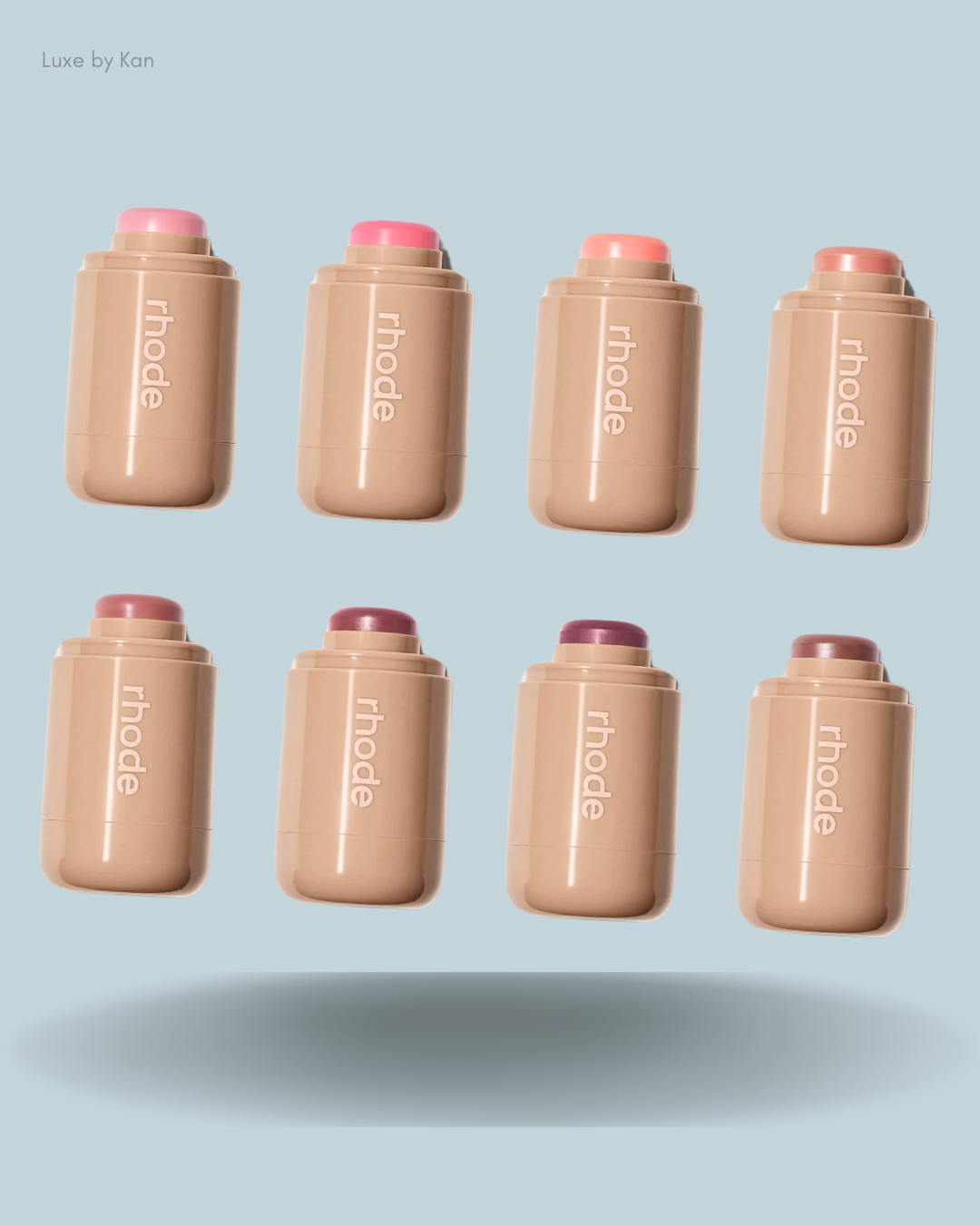 A displayed collection of eight rhode makeup sticks in various shades.