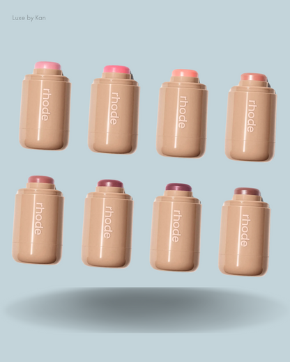 A displayed collection of eight rhode makeup sticks in various shades.