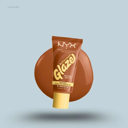 NYX Professional Makeup Buttermelt Glaze Skin Tint SPF 30 tube and swatch on blue background — LBK