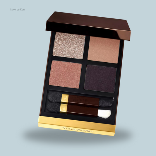 A luxurious Tom Ford Eye Colour Quad palette featuring four shades: shimmering beige, soft pink, rich plum, and dark matte, with applicators included.