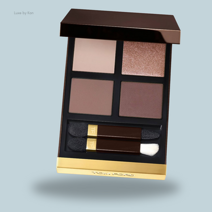 Tom Ford eyeshadow palette featuring four shades: soft cream, matte brown, deep mauve, and shimmering bronze, with two applicators included.