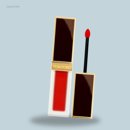 Bright red Tom Ford liquid lipstick in a sleek glass tube with a gold and brown cap, accompanied by a soft applicator.