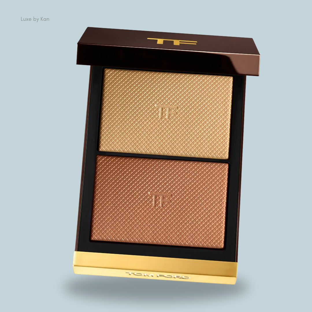 Two-toned Tom Ford highlighting palette featuring a gold top shade and a warm bronze bottom shade, in a sleek black and gold compact.