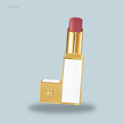 A stylish Tom Ford Ultra Shine Lip Colour lipstick tube with a light pink bullet, featuring a sleek design and a white panel.
