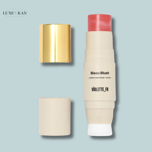 Bisou blush matte cream blush stick with a brush tip.