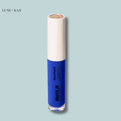 Blue eyeshadow paint in a sleek tube with a white cap, labeled "Violette FR" for vivid eye makeup application.