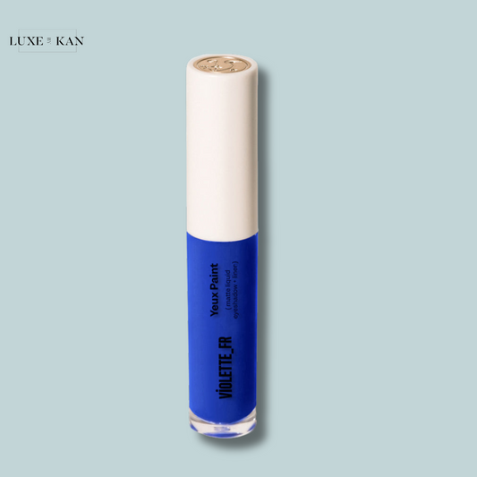 Blue eyeshadow paint in a sleek tube with a white cap, labeled "Violette FR" for vivid eye makeup application.