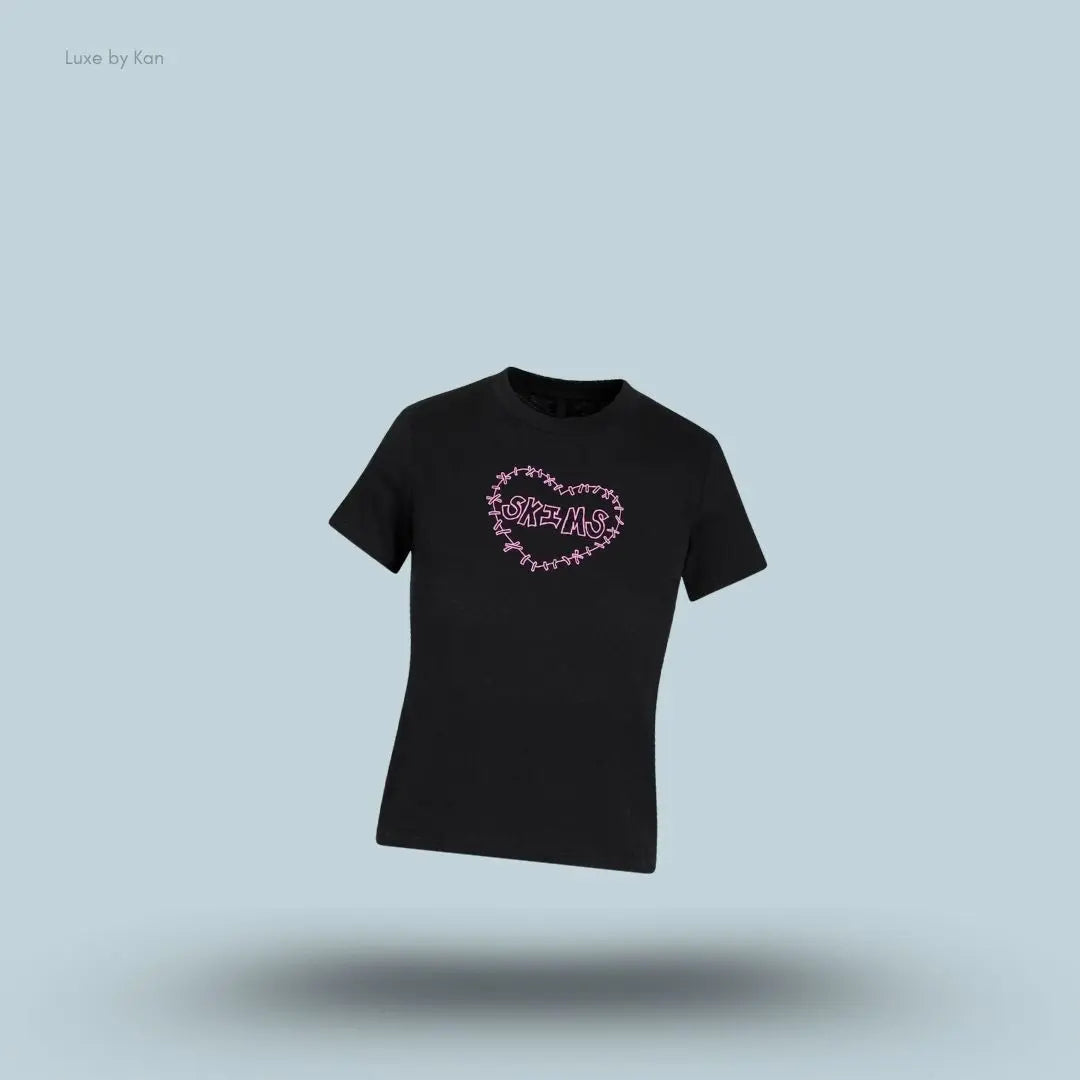 SKIMS Worn In Jersey T-Shirt in Washed Onyx Skims Heart, flat lay on light blue background
