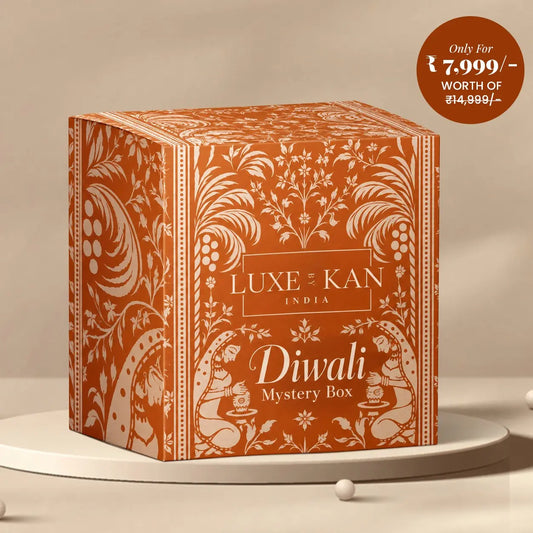 Luxe by Kan Diwali Mystery Box terracotta gift box with traditional Indian motifs on a beige podium, premium ₹7,999 edition