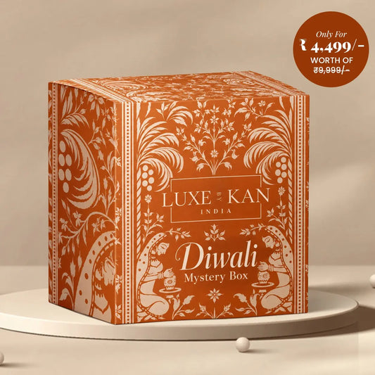 Luxe by Kan Diwali Mystery Box terracotta gift box with traditional Indian motifs on a beige podium, classic ₹4,499 edition