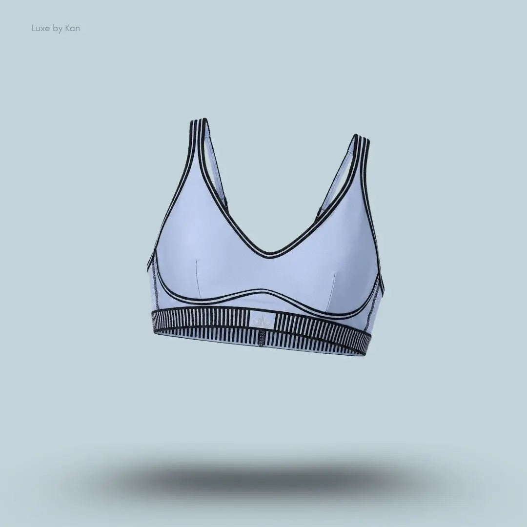 Alo Airlift Line Up Bra in Winter Frost, flat lay on light blue background