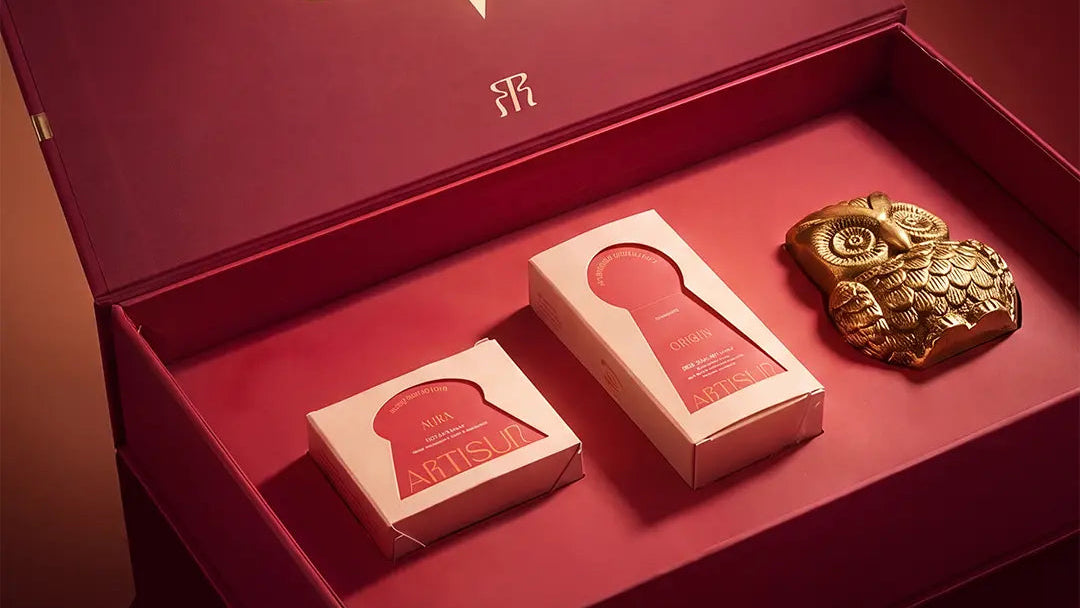 Artisun Vahana Vol 1 open Diwali box with Origin and Aura cartons and a brass owl keepsake