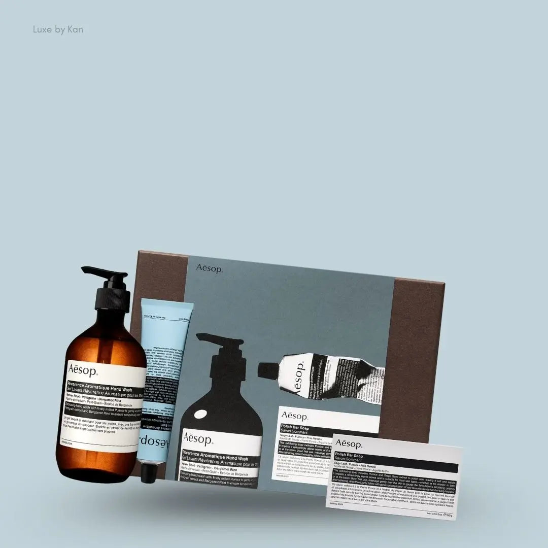 Aesop Reverence Hand Trio set with hand wash, hand balm and bar soap, flat lay on light blue background