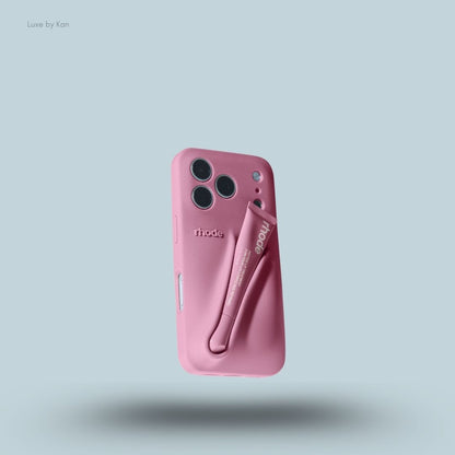Rhode phone case in purple against blue background; the word "rhode" embossed on the back, with loop for lip balm.