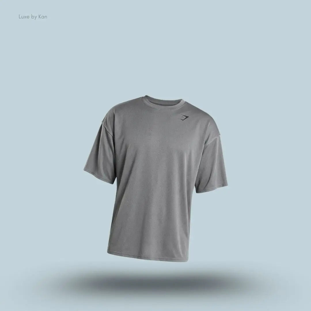 Gymshark Washed Pastels T-Shirt in black displayed on a blue background with an oversized short-sleeve design