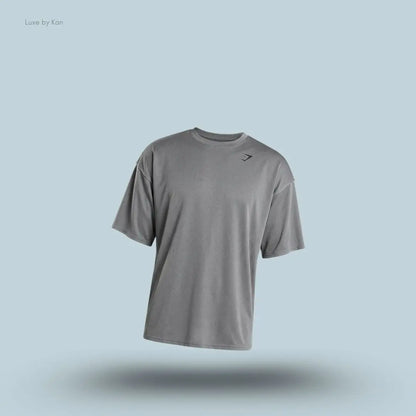 Gymshark Washed Pastels T-Shirt in black displayed on a blue background with an oversized short-sleeve design