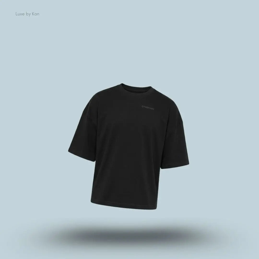 Gymshark Accent Boxy T-Shirt in black displayed on a blue background with an oversized boxy short-sleeve design