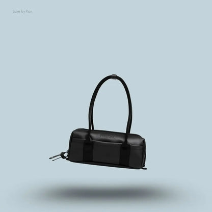 Gymshark Everyday Baguette Bag in black displayed on a blue background with a classic short-handle design