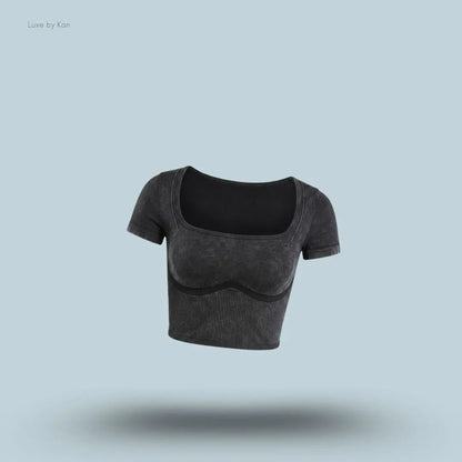 Gymshark x Bratz Crop Top in black displayed on a blue background with a body-fit cropped design
