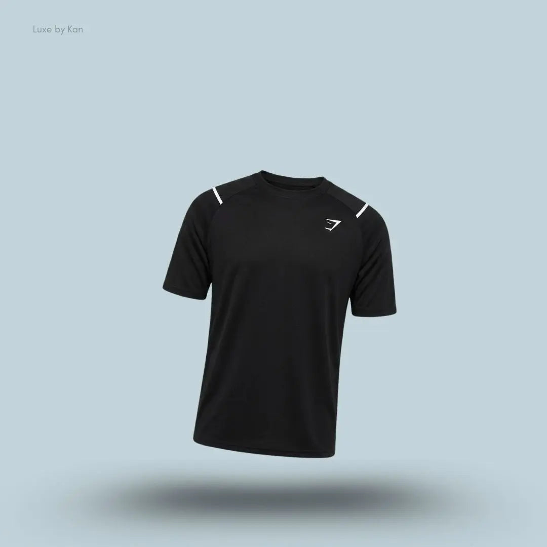 Gymshark Arrival Contrast T-Shirt in black displayed on a blue background with contrast shoulder piping and short sleeves