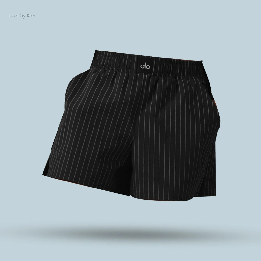 Alo Pinstripe Daylight Boxer Short in Black pinstripe, flat lay on light blue background